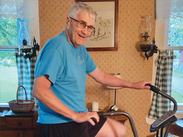 Dave Hosterman working out on an exercise bike at home.