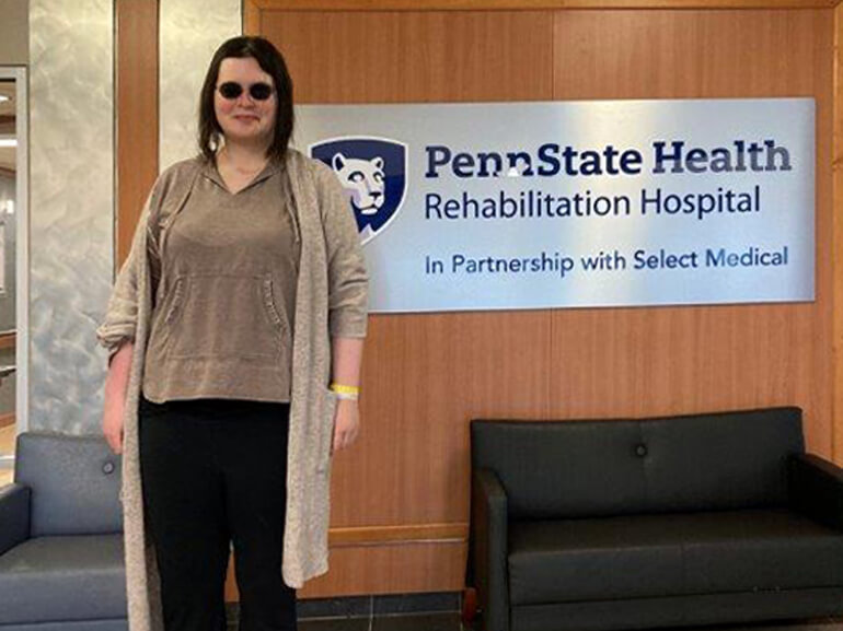 Molly Edwards stands in the hospital lobby following her successful rehabilitation.